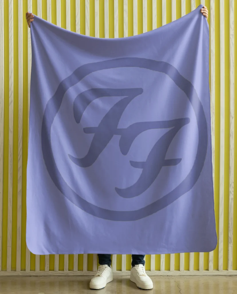 man holding flannel blanket featuring design from rock band foo fighters on sale at the foo fighters merch store